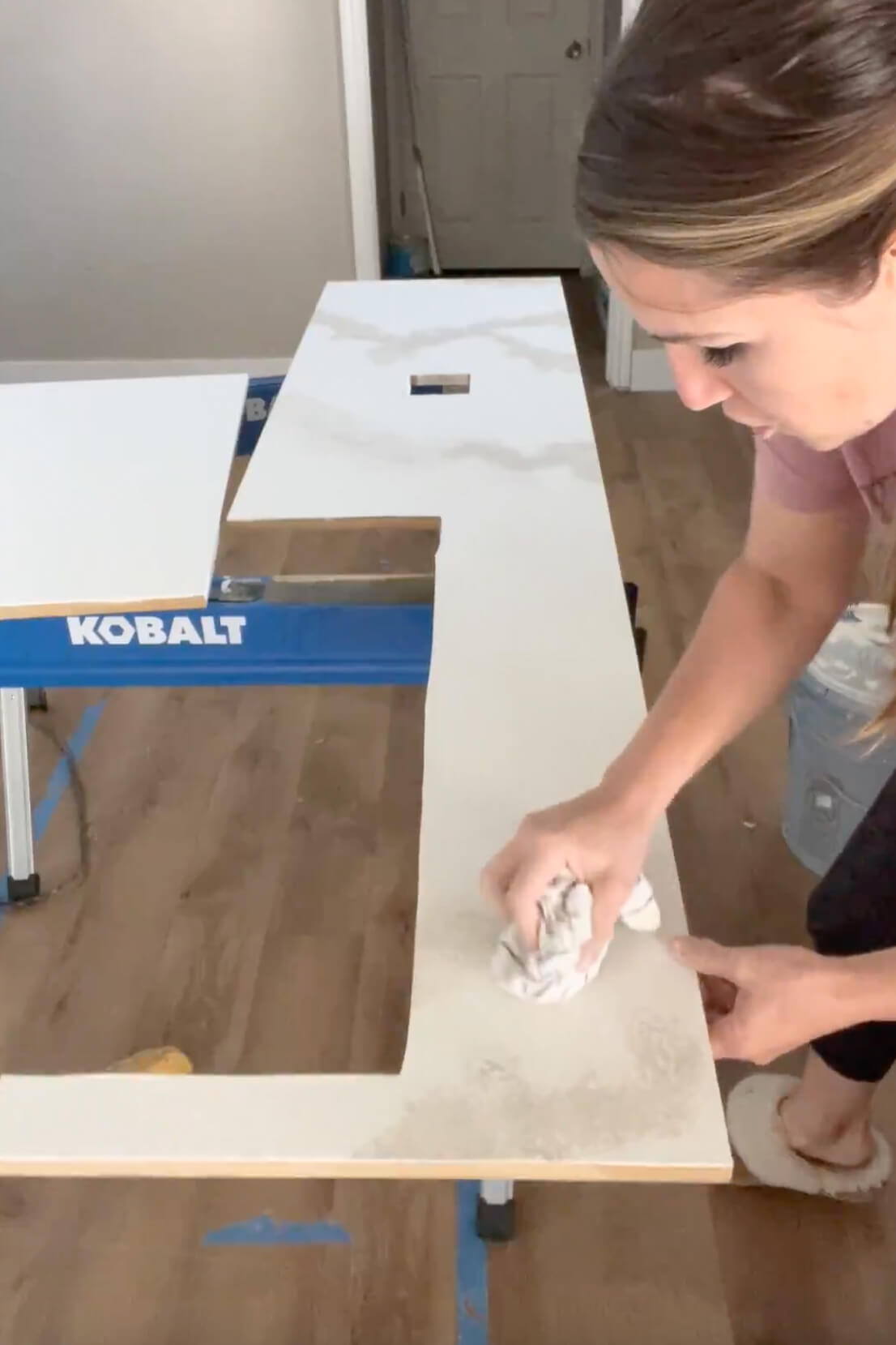 Painting a countertop for a faux marble finish. 